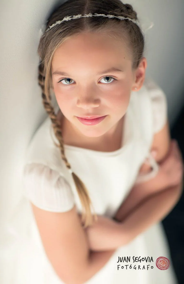 Galería de Fotos de Niñas de Comunión en Estudio - Fotógrafo de Tarragona Fotografia de una nina con trenza y mirada para su reportaje de comunion en el estudio del fotografo Juan Segovia en Tarragona